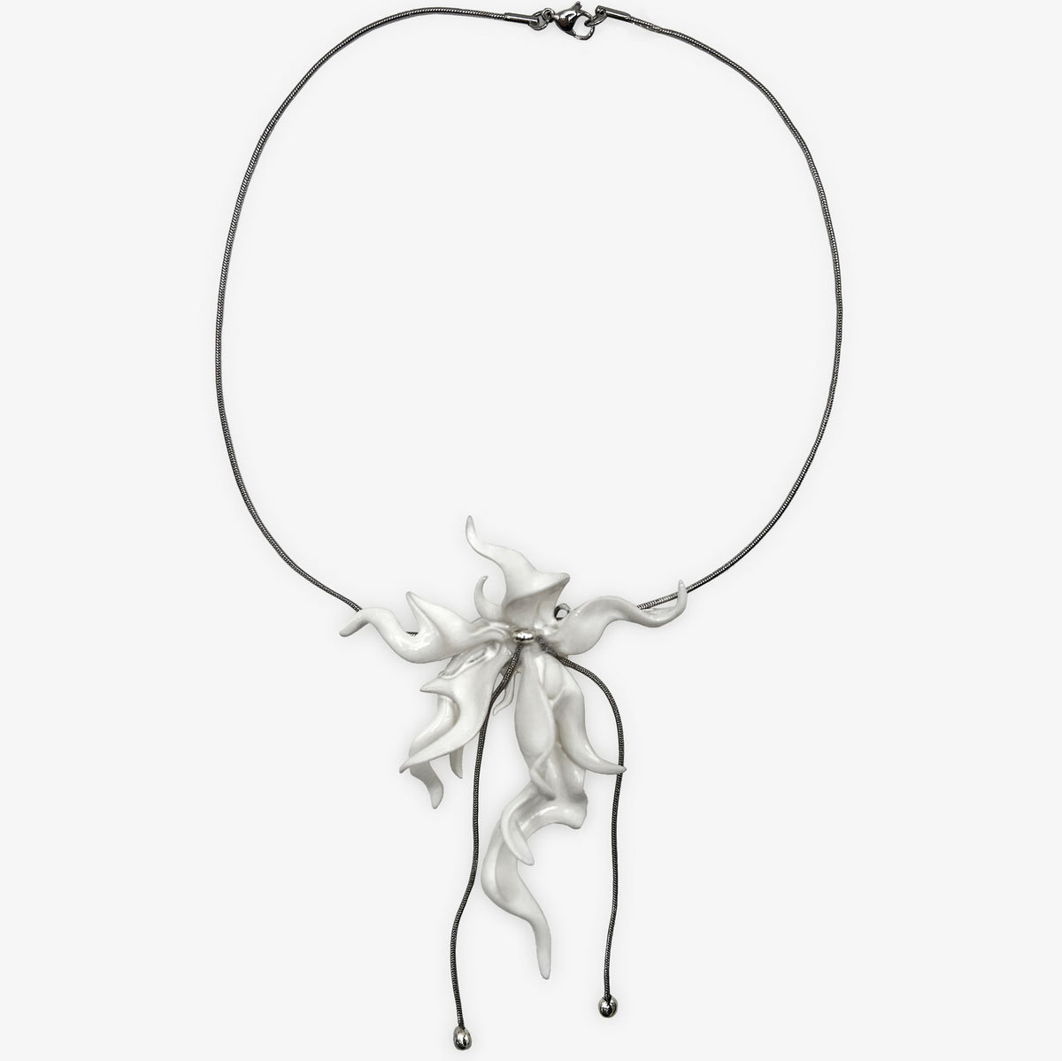 Silver necklace with a floral pendant on a white background
