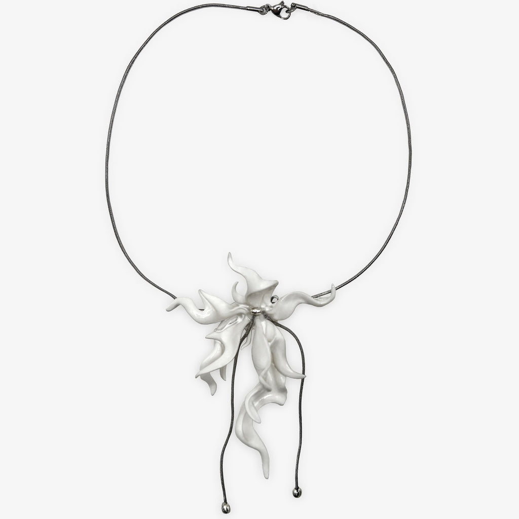 Silver necklace with a floral pendant on a white background