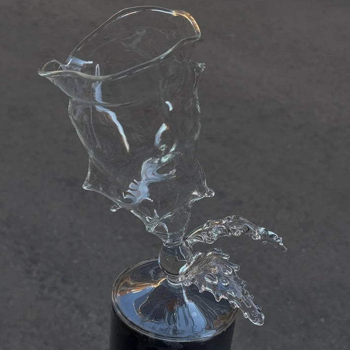 Clear glass sculpture on a dark gray background