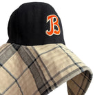 Black cap with orange 'B' logo on a neutral background