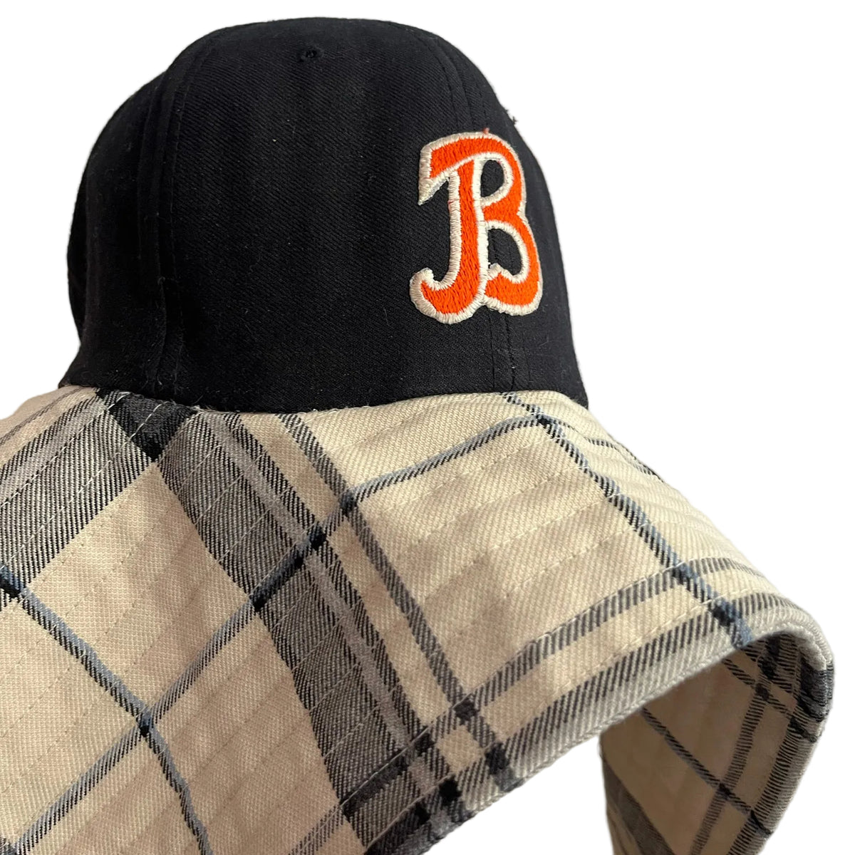 Black cap with orange 'B' logo on a neutral background